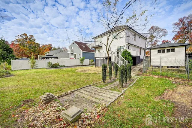 a view of a house with wooden floor and a small yard