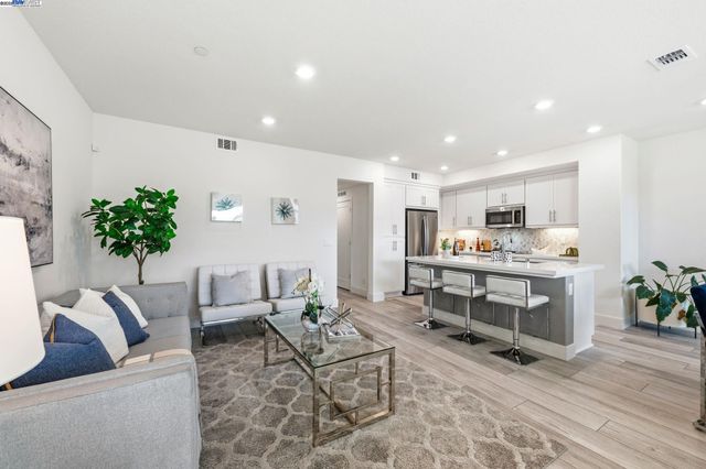 a living room with furniture and flowers