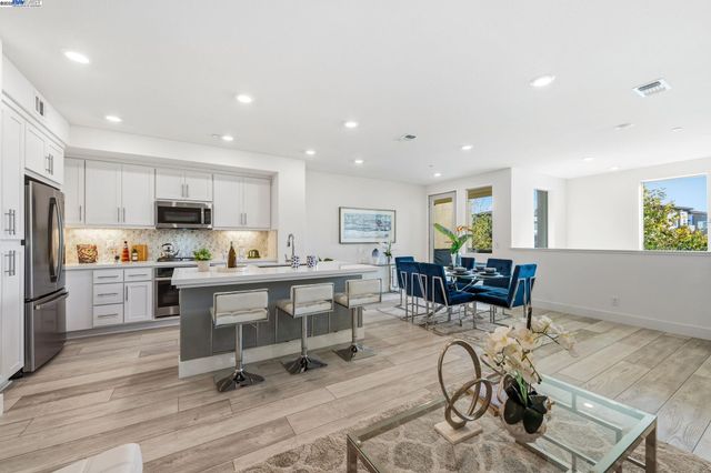 a view of kitchen with sink and breakfast area
