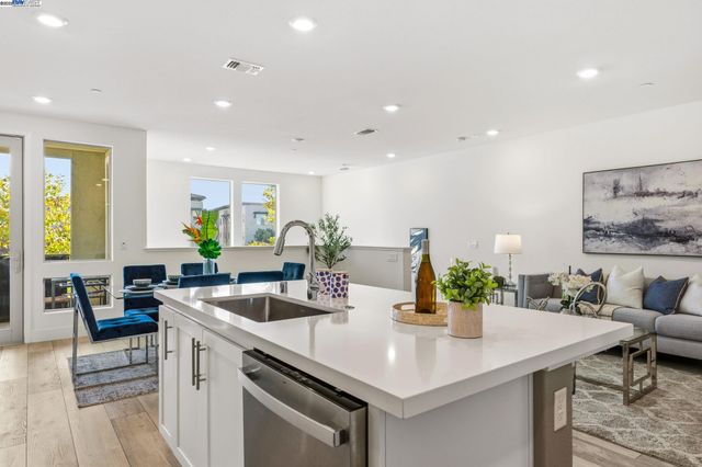 a kitchen with a sink a counter and chairs