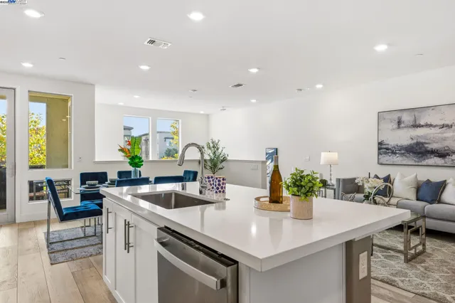 a kitchen with a sink a counter and chairs