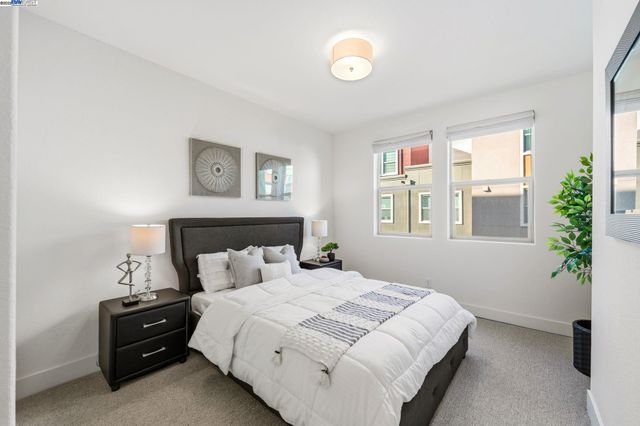 a bedroom with a bed and a potted plant