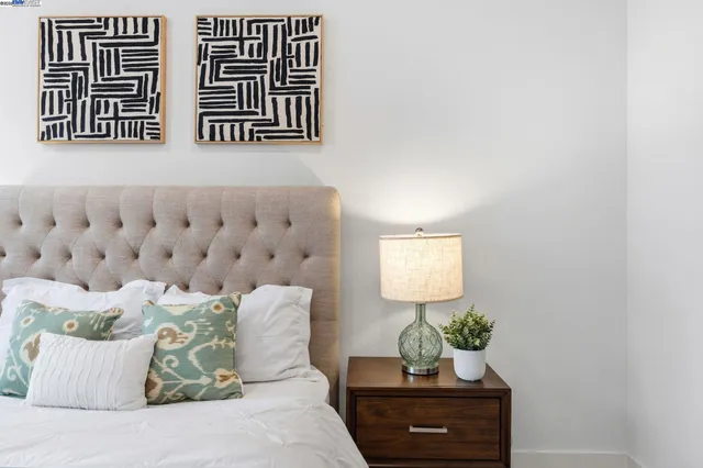 a bedroom with a large bed and a window