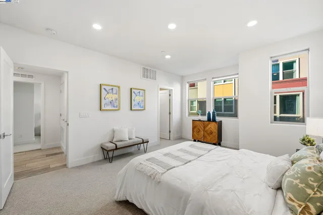 a bedroom with a bed and a painting