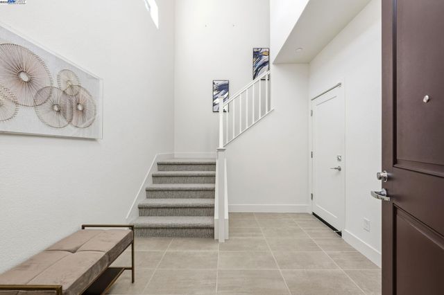 a view of entryway with stairs and a rug