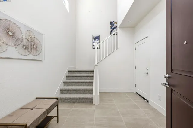 a view of entryway with stairs and a rug