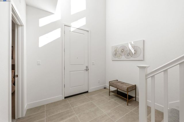 a living room with furniture and a painting on the wall