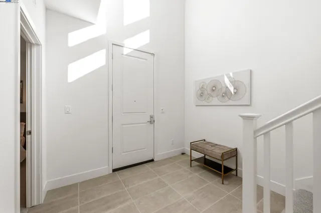 a living room with furniture and a painting on the wall