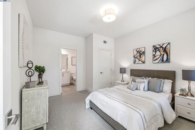 a bedroom with a bed and a couch