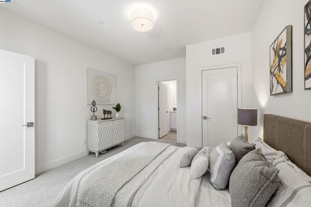 a bedroom with a white bed and a cabinets