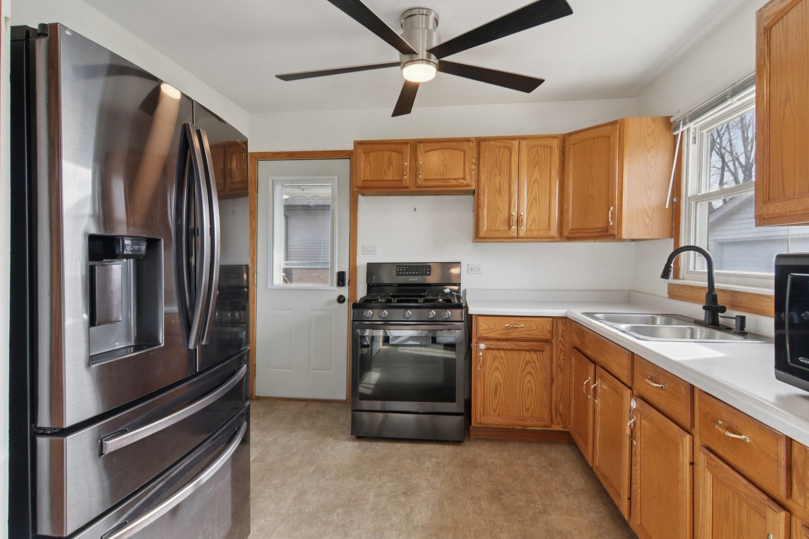 7416 Thomas Avenue Bridgeview, IL 60455 - Photo 16 of 32 a kitchen with stainless steel appliances granite countertop a refrigerator stove and sink