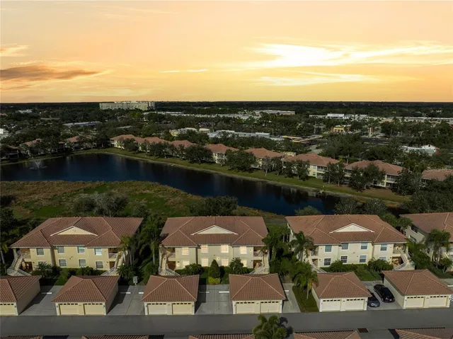 an aerial view of lake and residential houses with outdoor space