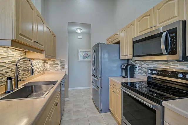 a kitchen with stainless steel appliances a stove sink microwave and cabinets