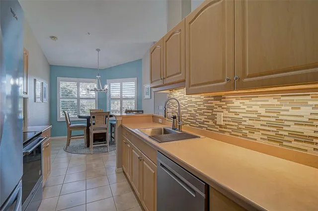 a view of a dining room with furniture a chandelier and wooden floor