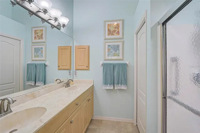 a en suite bathroom with a sink a mirror and a shower