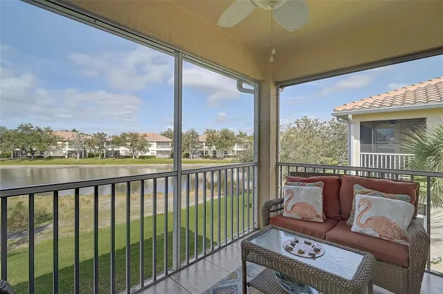 a living room with furniture and a floor to ceiling window