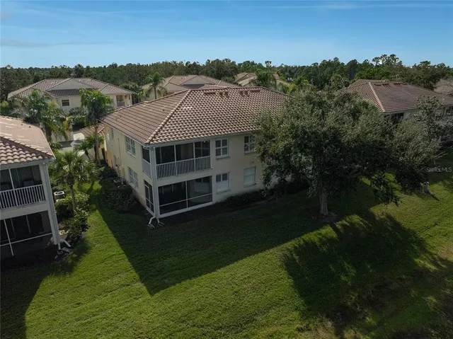 a yellow house with green field in front of it