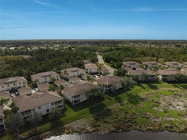 an aerial view of residential building with outdoor space and lake view