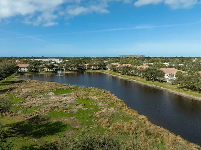 an aerial view of a house with a lake view