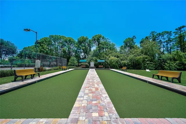 a view of a patio with lawn chairs under an umbrella