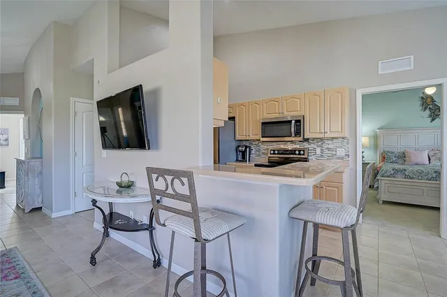 a large kitchen with kitchen island a sink table and chairs