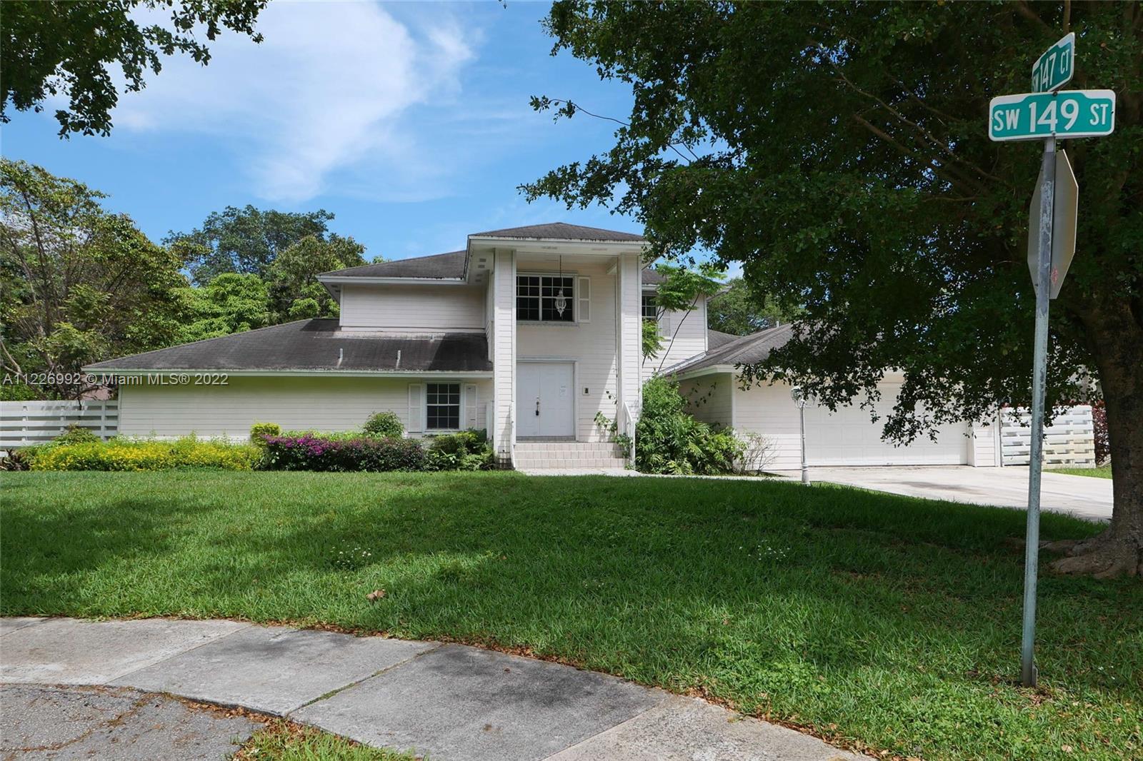 14830 Southwest 149th Street Miami, FL 33196 - Photo 1 of 25 a view of a house with a yard and a garden