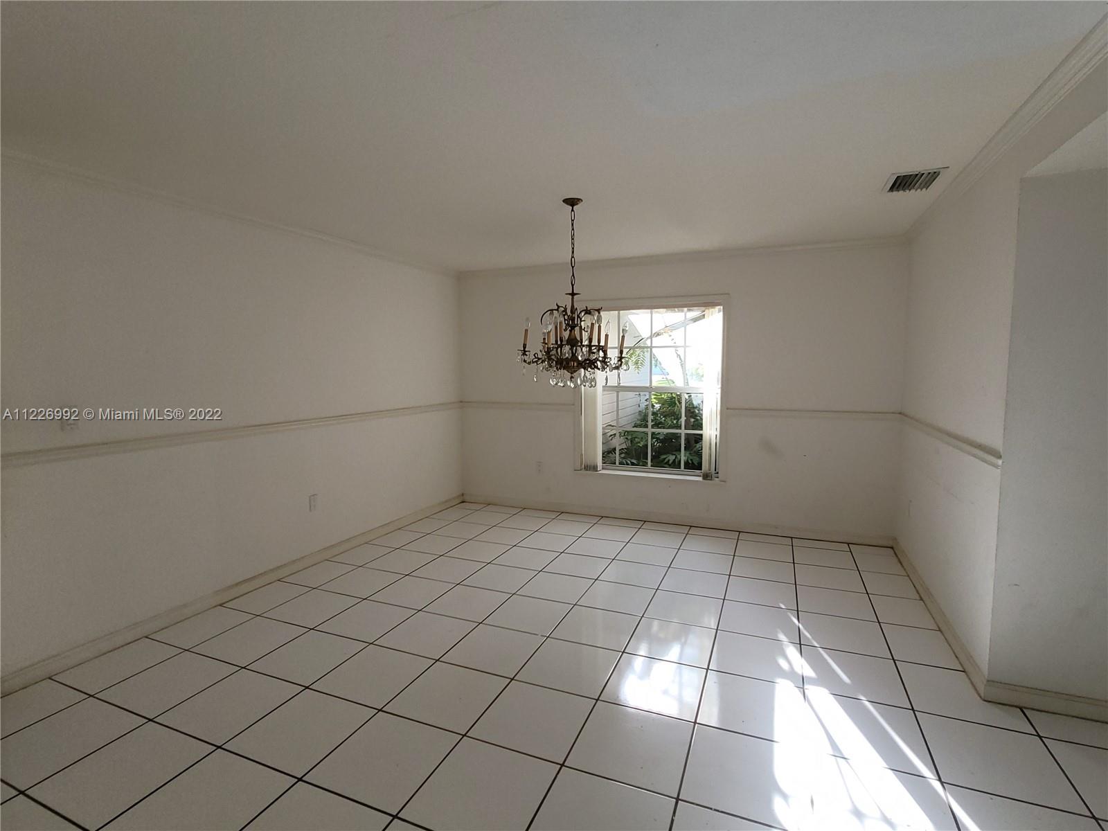 14830 Southwest 149th Street Miami, FL 33196 - Photo 11 of 25 a view of a room with an empty space and a window