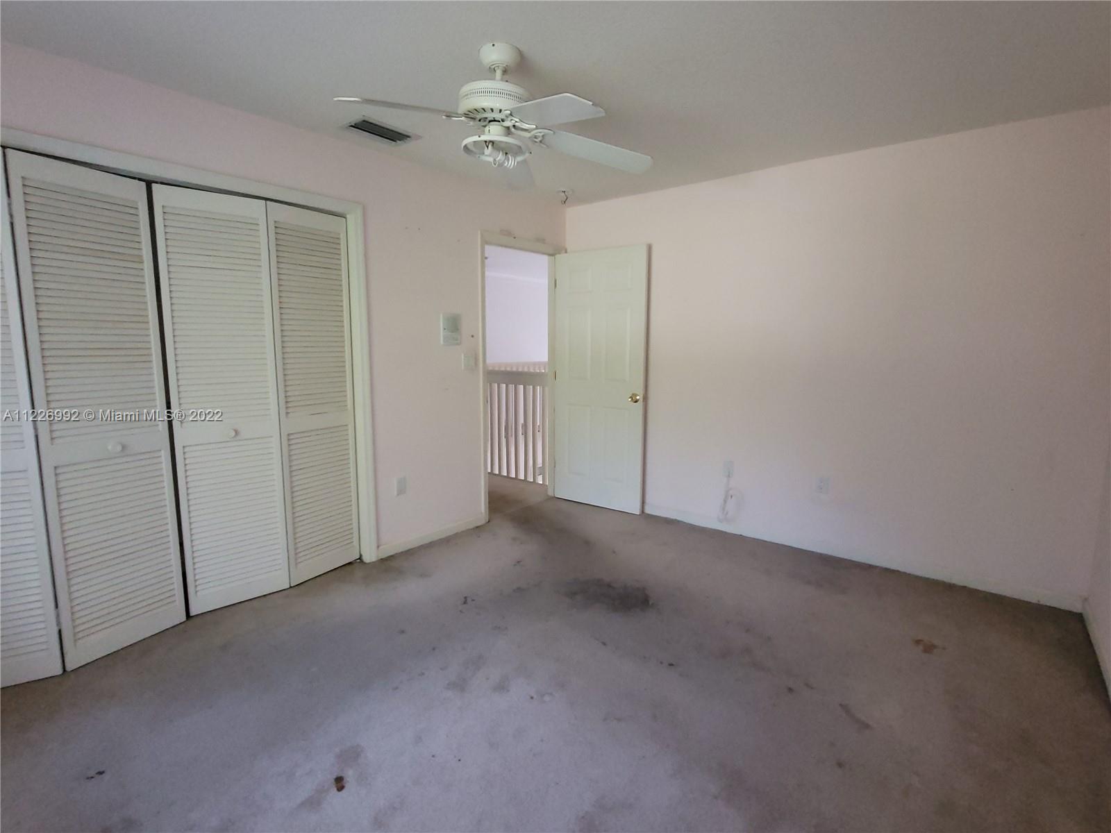 14830 Southwest 149th Street Miami, FL 33196 - Photo 20 of 25 an empty room with a ceiling fan and a window