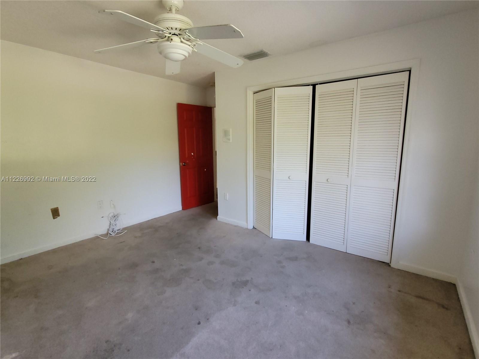 14830 Southwest 149th Street Miami, FL 33196 - Photo 23 of 25 a view of an empty room and a ceiling fan window