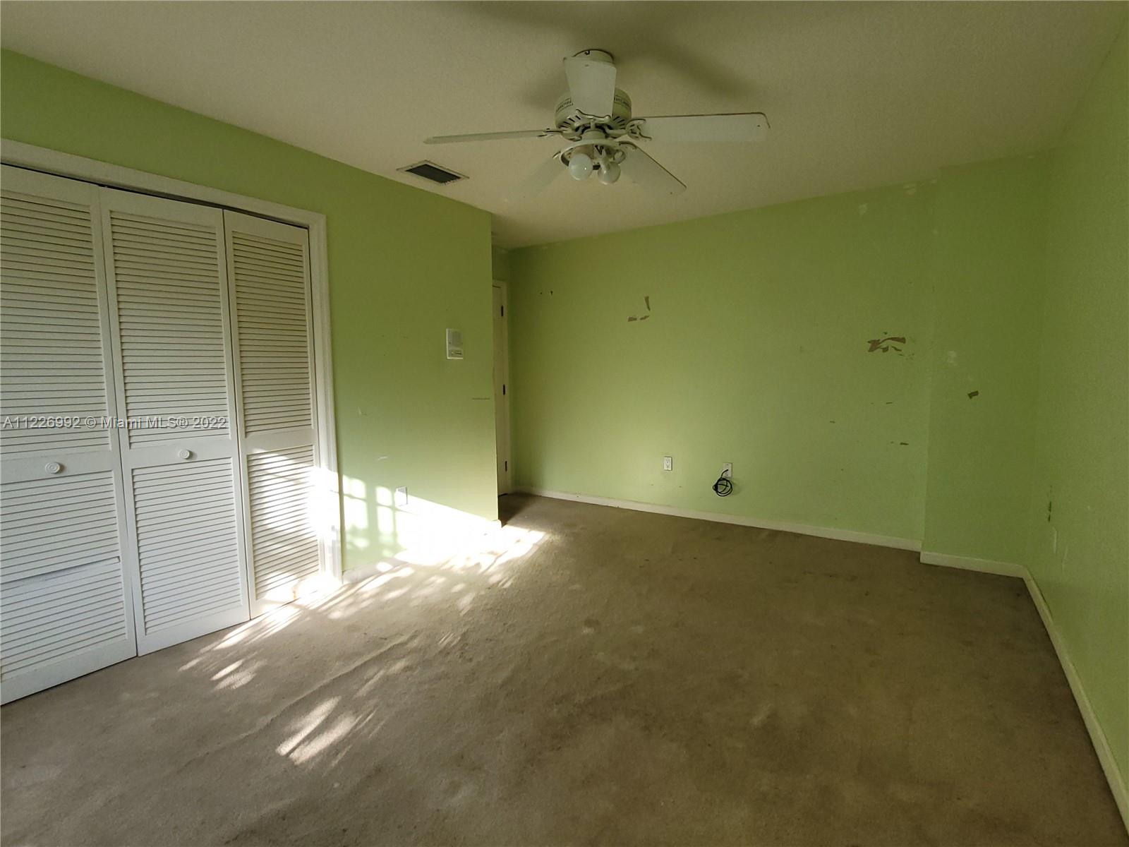 14830 Southwest 149th Street Miami, FL 33196 - Photo 24 of 25 a view of a livingroom with a ceiling fan and window