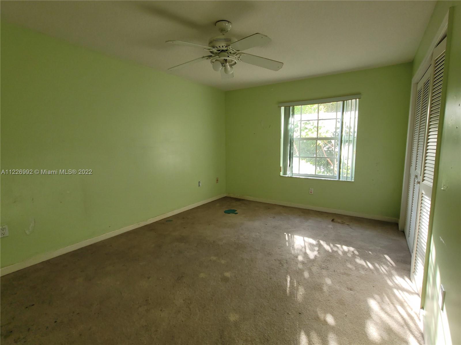 14830 Southwest 149th Street Miami, FL 33196 - Photo 25 of 25 an empty room with a window and a ceiling fan