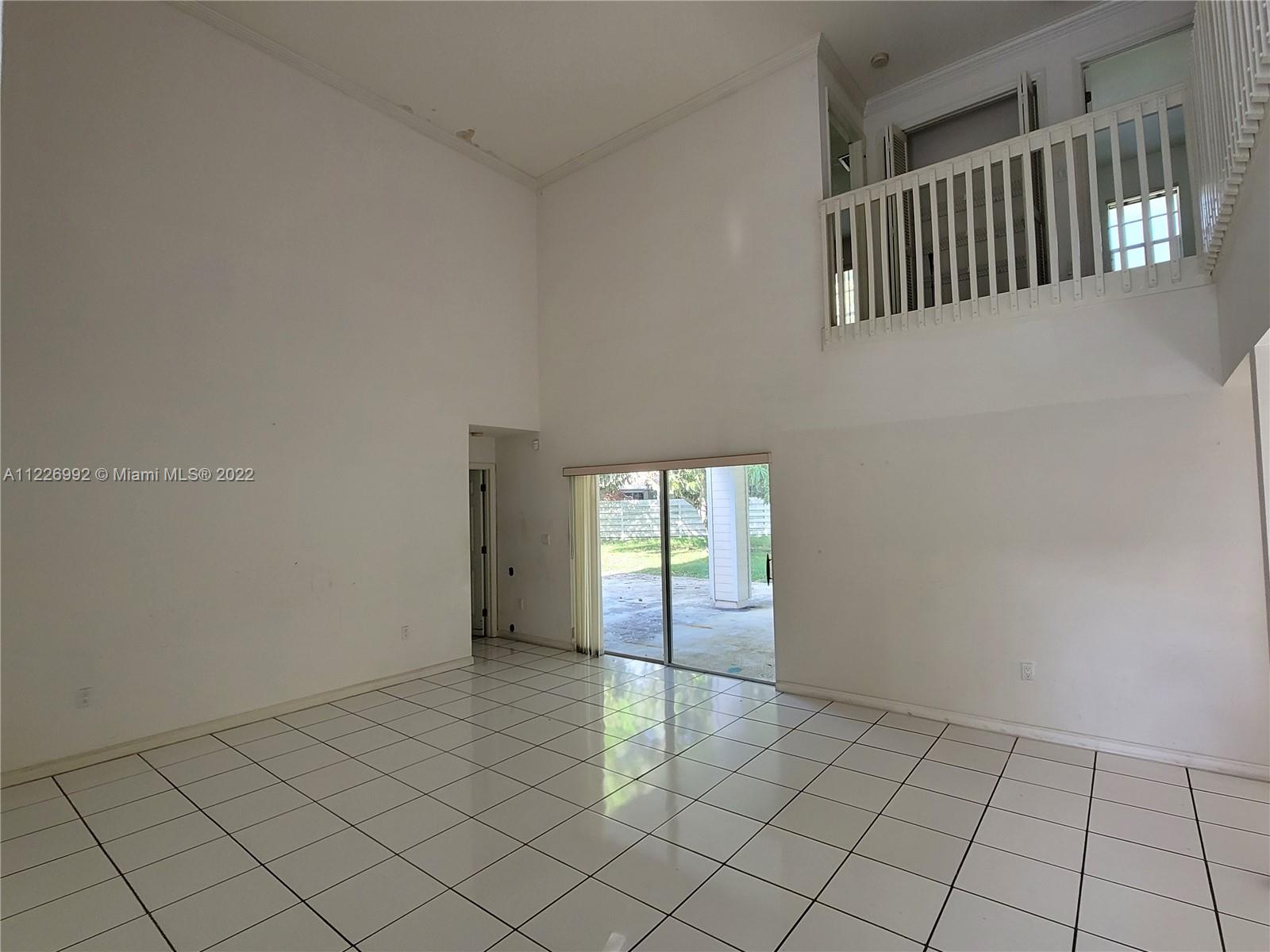 14830 Southwest 149th Street Miami, FL 33196 - Photo 3 of 25 an empty room with windows