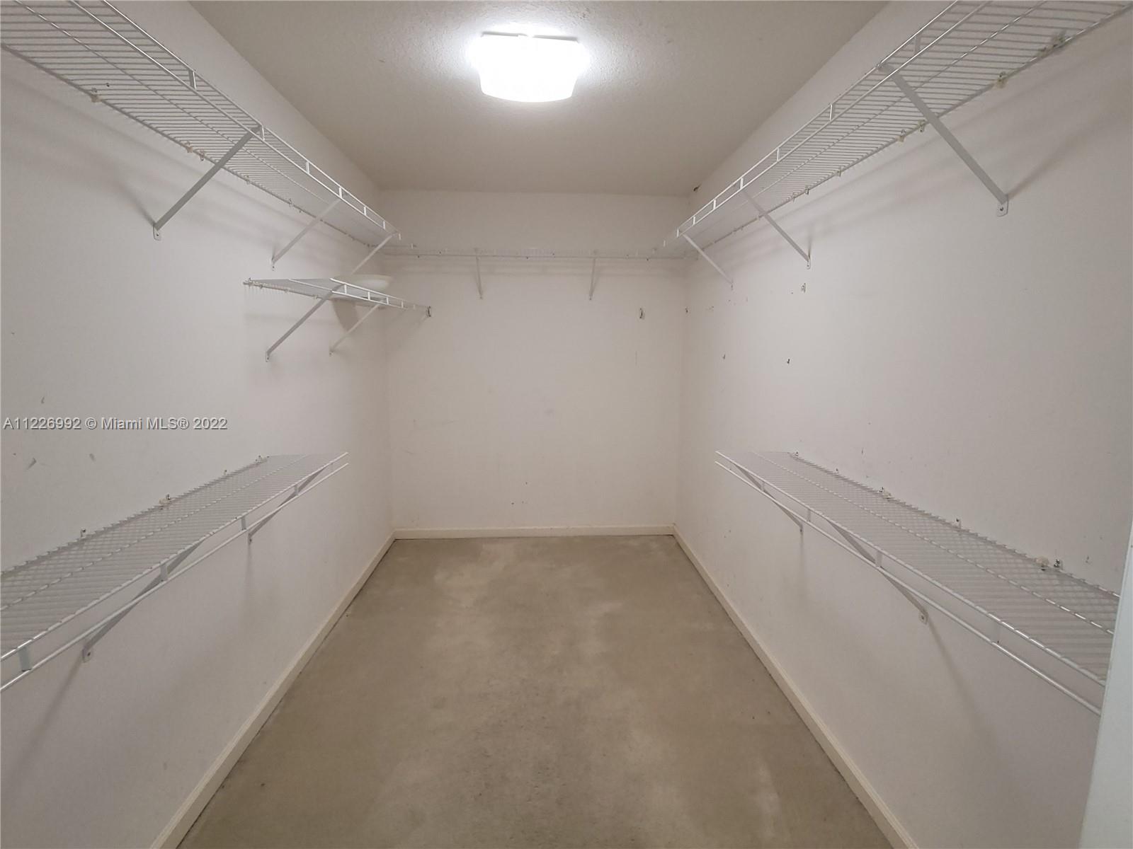 14830 Southwest 149th Street Miami, FL 33196 - Photo 10 of 25 a view of a room with racks on the wall