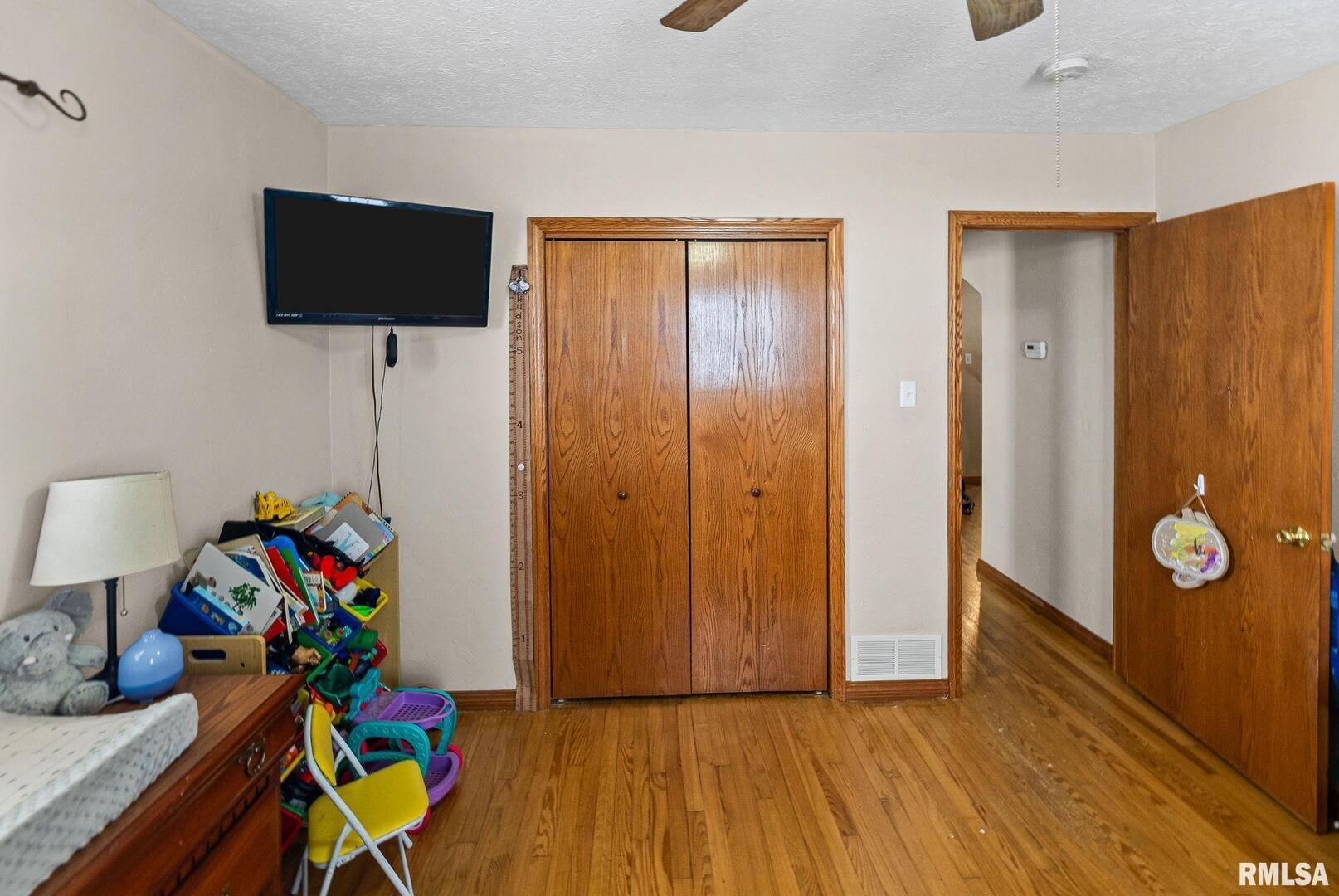 7302 Hoffman Road Centralia, IL 62801 - Photo 22 of 39 a view of an empty room with wooden floor and a flat screen tv