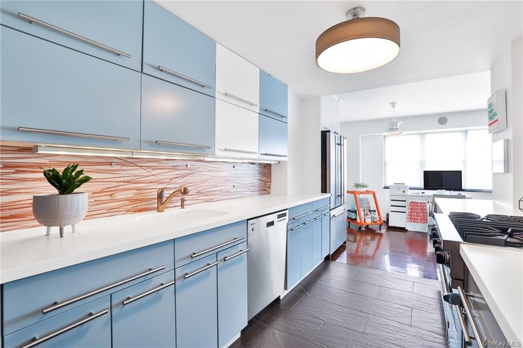 a kitchen with lots of counter space and wooden floor