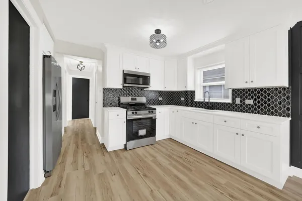a kitchen with stainless steel appliances a refrigerator sink and stove