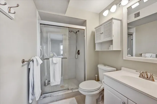 a bathroom with a sink toilet and shower
