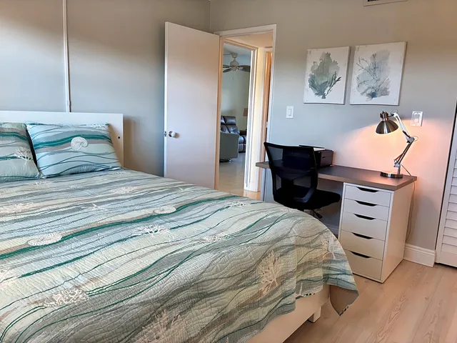 a bedroom with a bed and a bookshelf