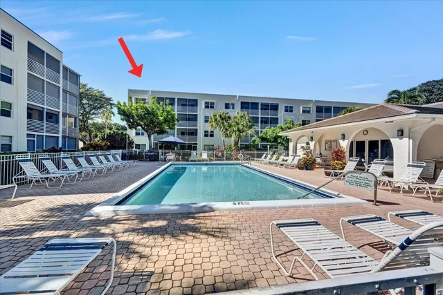 a view of a swimming pool with sitting area