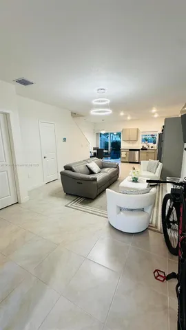 a room with a table chairs and a workspace