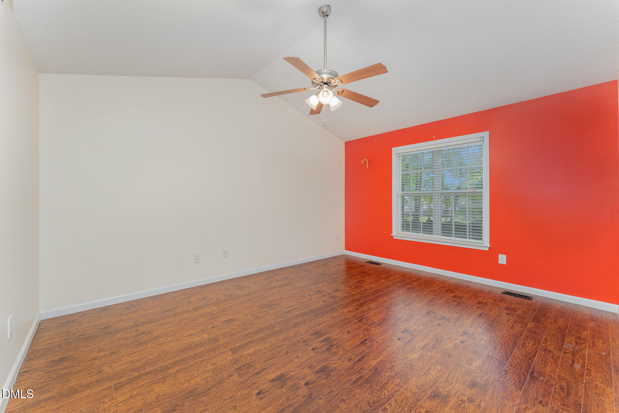 687 West Watson Road Benson, NC 27504 - Photo 11 of 25 an empty room with a window and ceiling fan