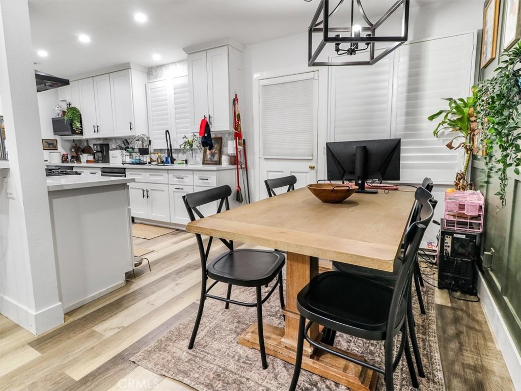 6502 Dos Rios Road Downey, CA 90240 - Photo 12 of 21 a kitchen with a dining table chairs and microwave