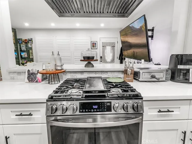 a stove top oven sitting inside of a kitchen