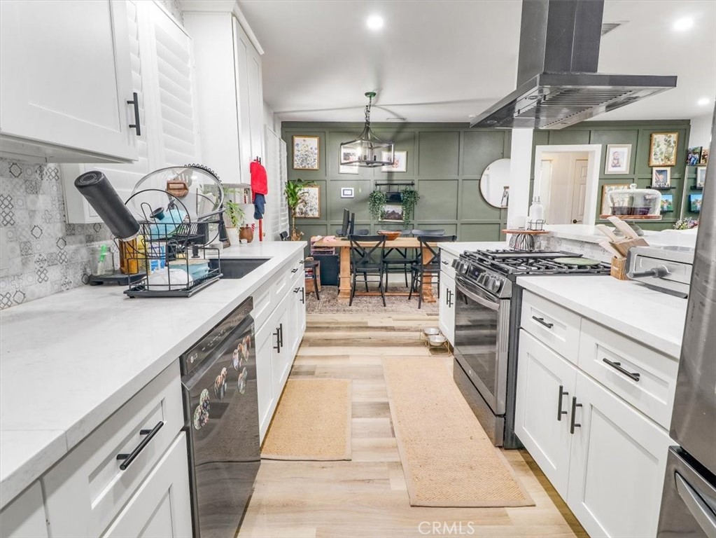 6502 Dos Rios Road Downey, CA 90240 - Photo 15 of 21 a kitchen with stainless steel appliances granite countertop a stove a sink and a refrigerator