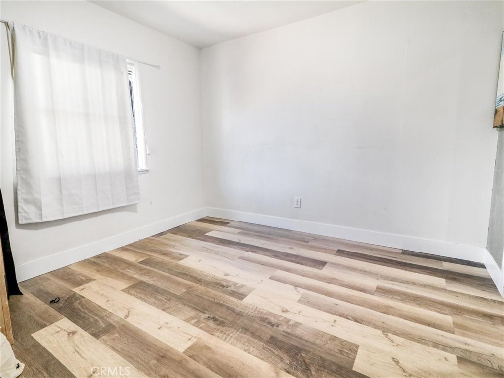 6502 Dos Rios Road Downey, CA 90240 - Photo 20 of 21 a view of a room with wooden floor and a window