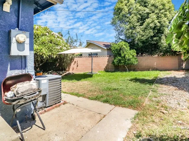 a view of a chair and table in backyard