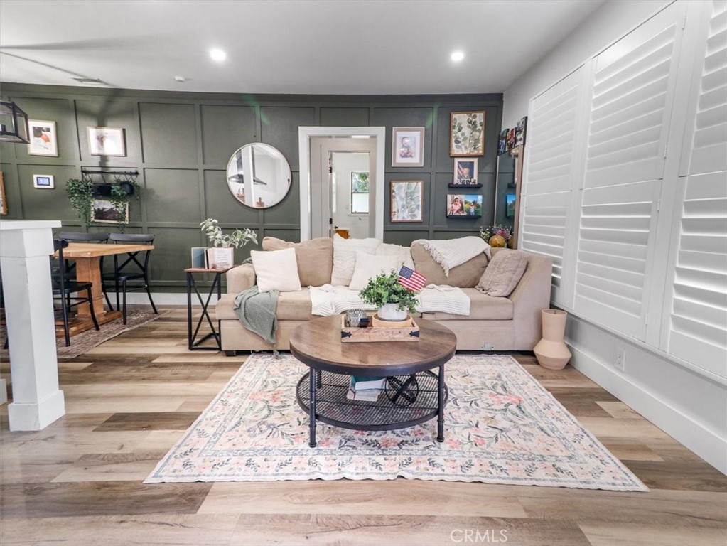 6502 Dos Rios Road Downey, CA 90240 - Photo 9 of 21 a living room with furniture a table and wooden floor