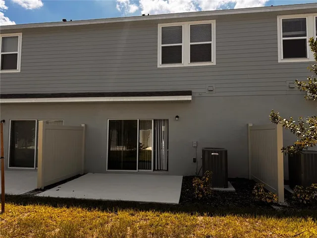 a view of backyard of house with car parked