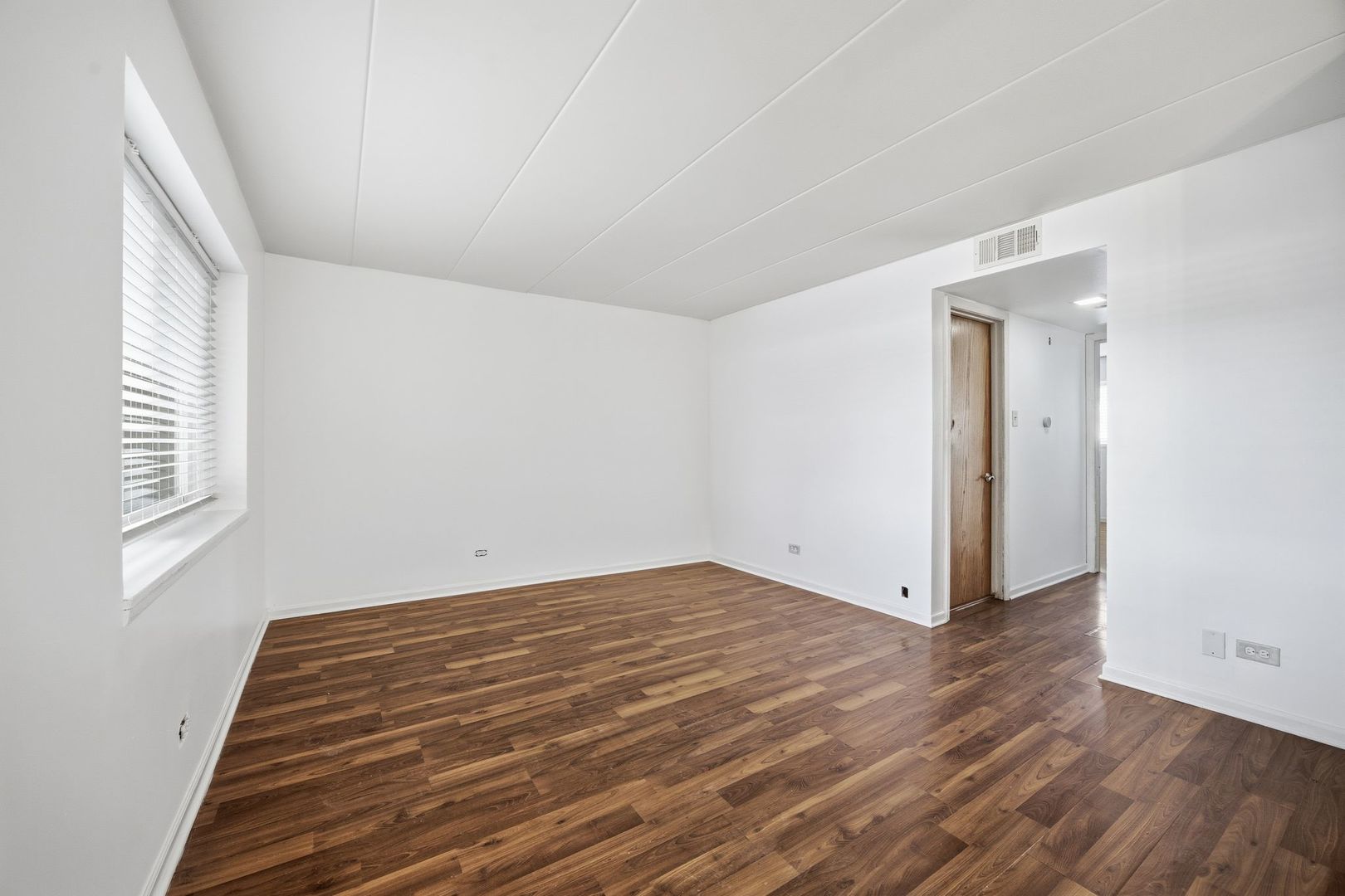 4618 River Road, Unit 1D Schiller Park, IL 60176 - Photo 3 of 12 a view of room with wooden floor and window