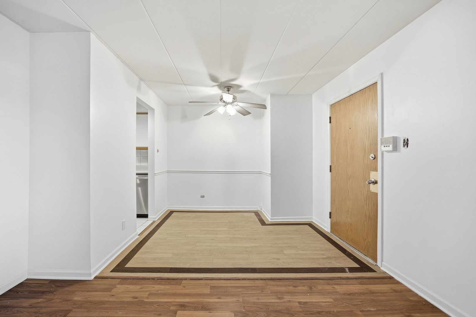 4618 River Road, Unit 1D Schiller Park, IL 60176 - Photo 5 of 12 a view of a room with wooden floor and white walls